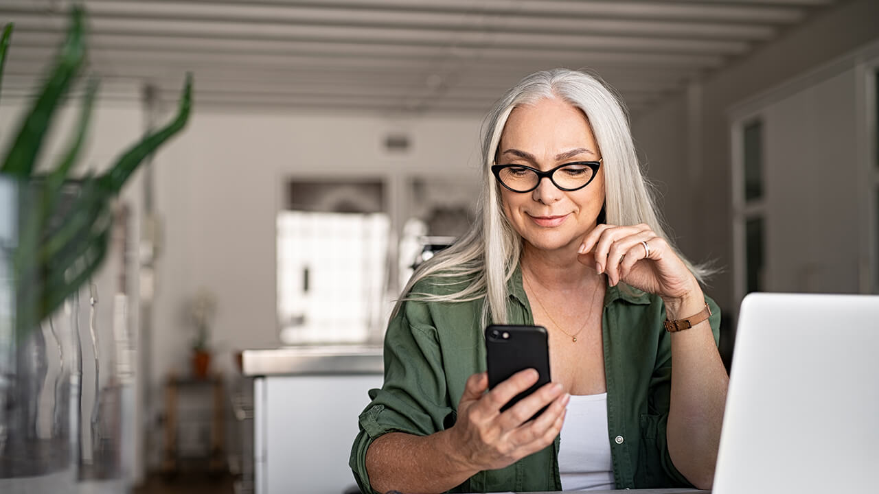 Professional female CPA in her home office on phone and laptop