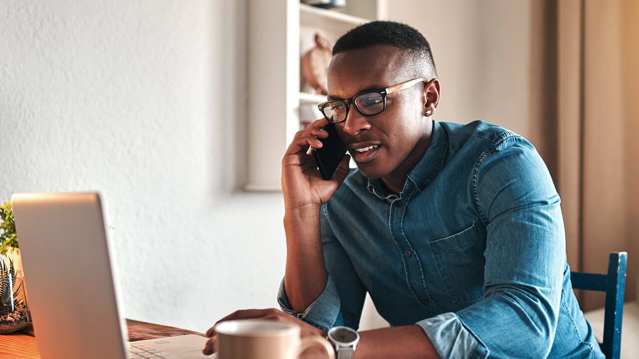 Young male professional CPA on a call with a client while working from home