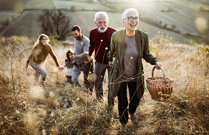 Family outside walking in a field