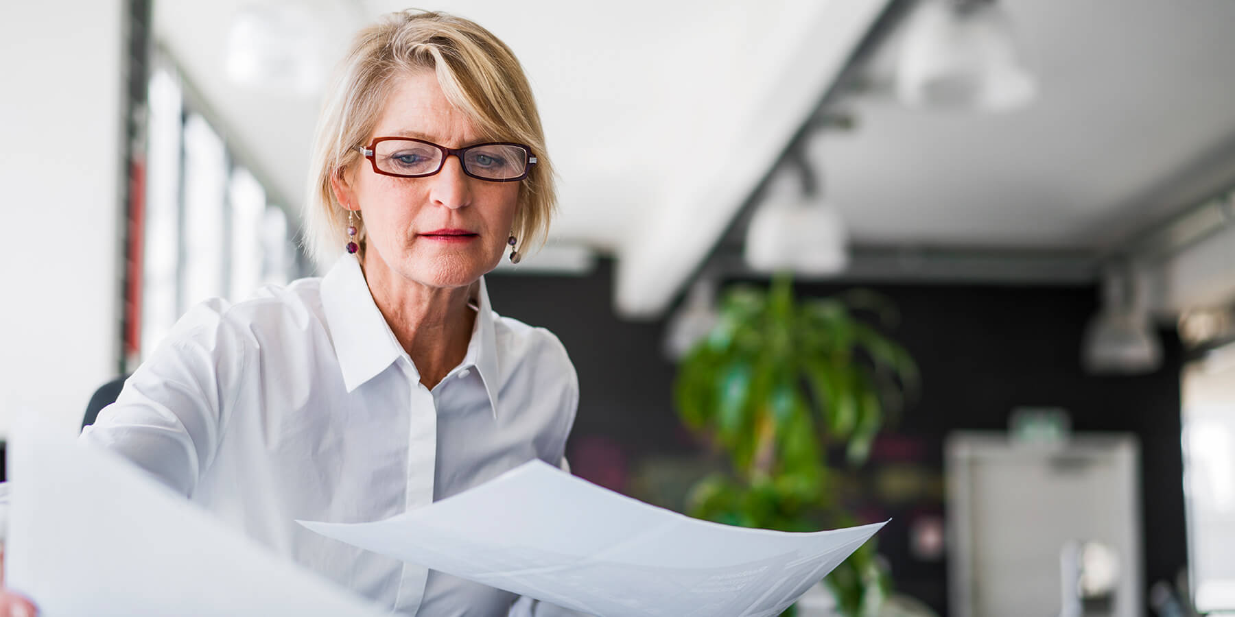 Professional female CPA reviewing client documents