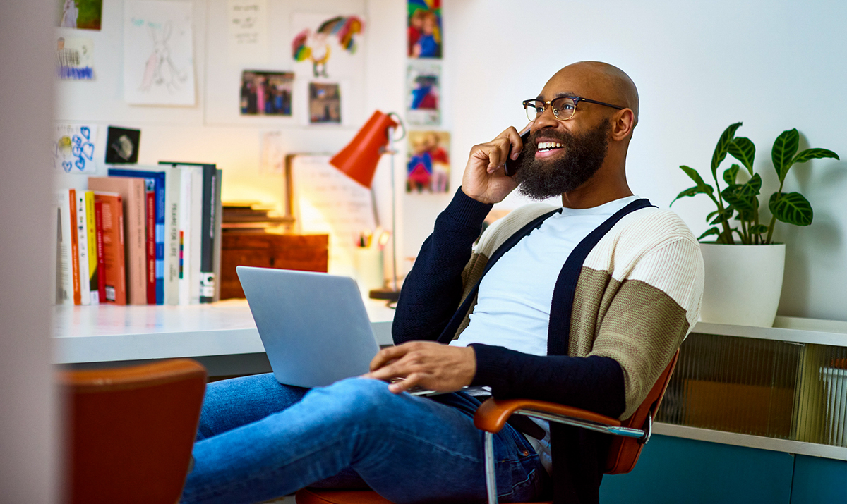 Man talking on the phone with a computer