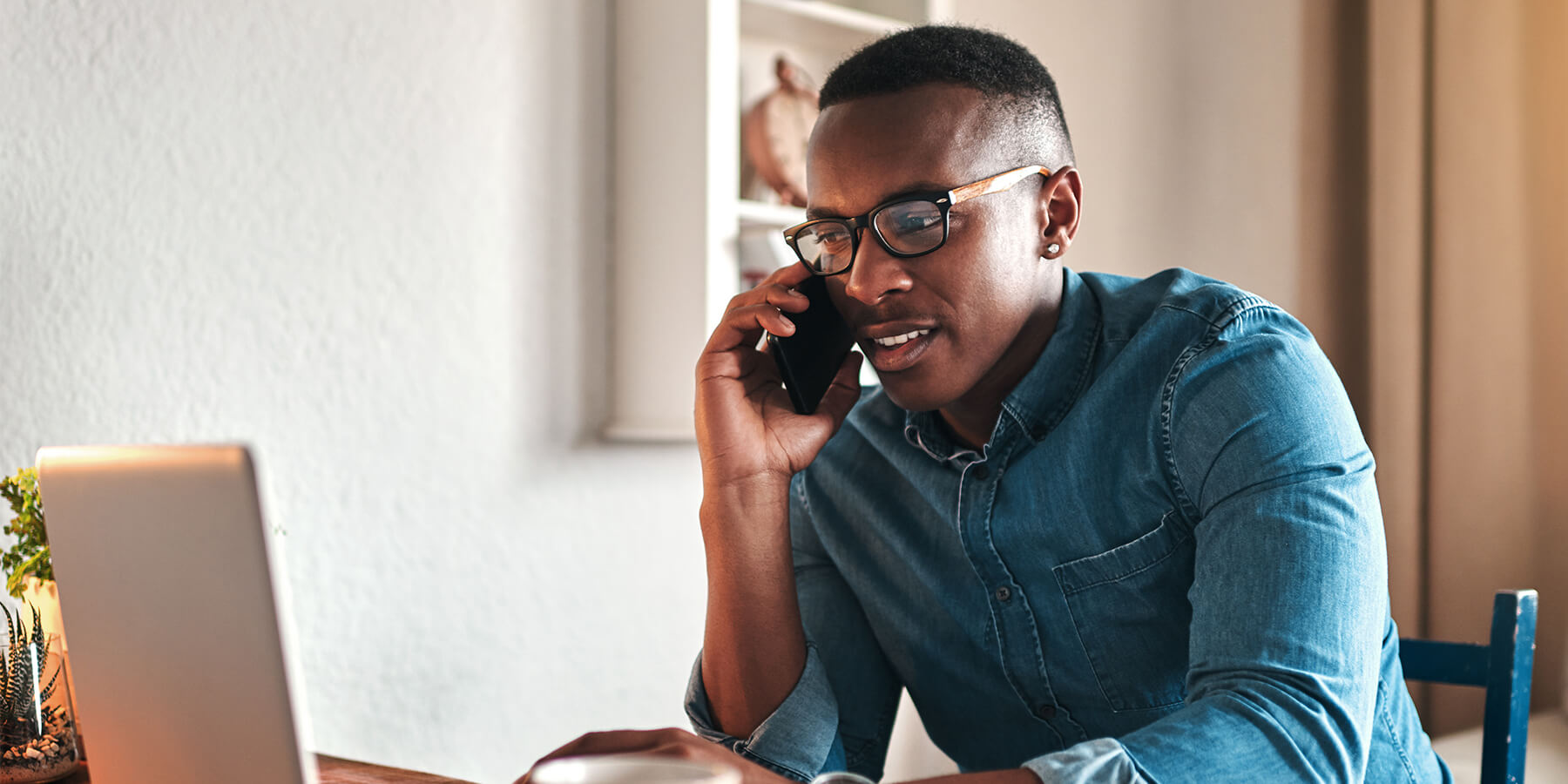 Young male professional CPA on a call with a client while working from home