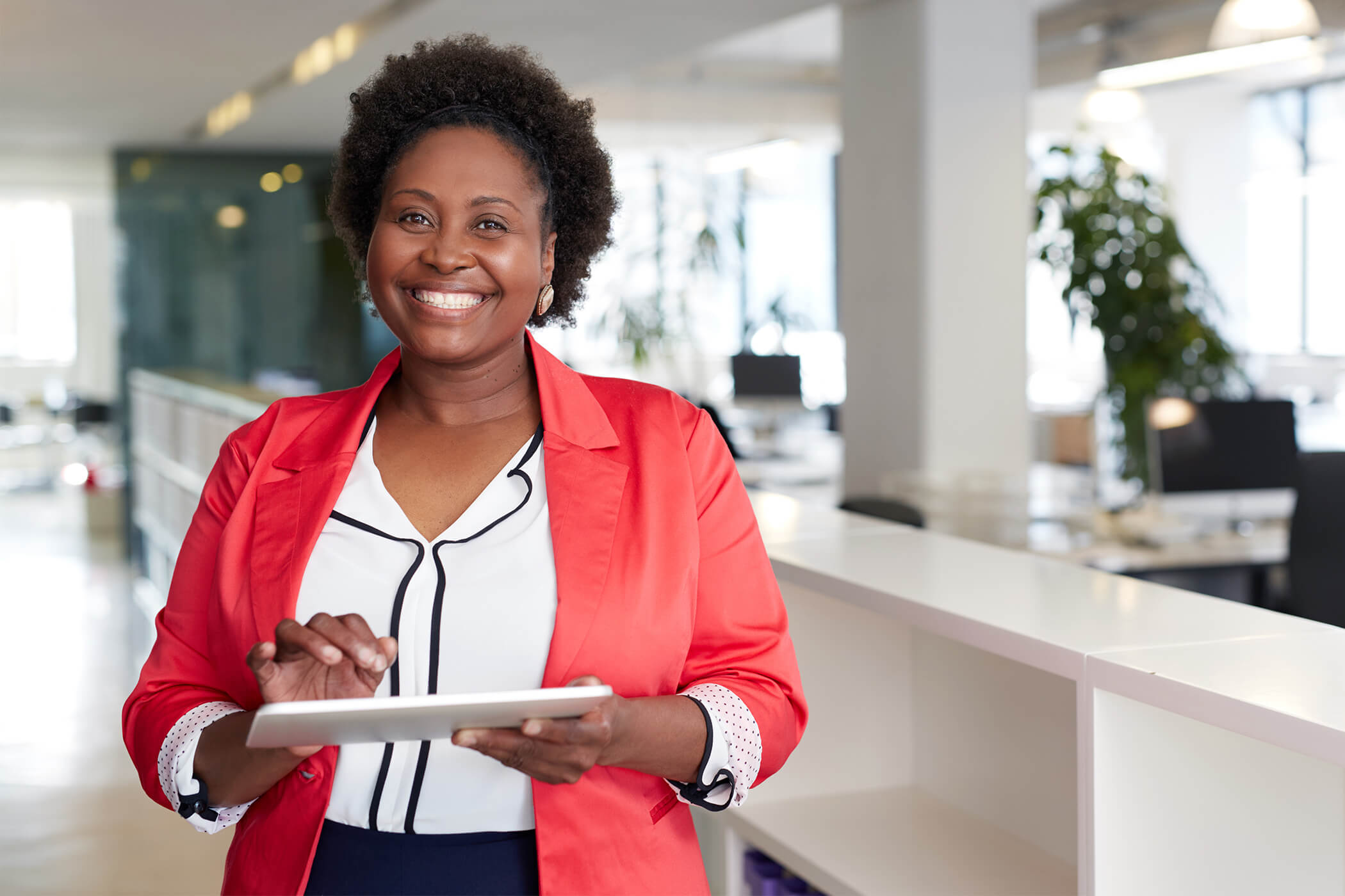 Professional female CPA in office environment on tablet