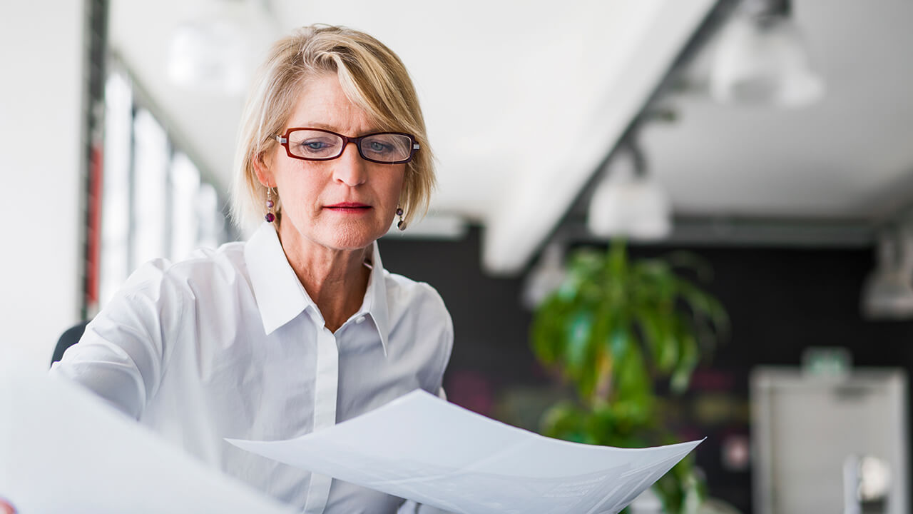 Professional female CPA reviewing client documents