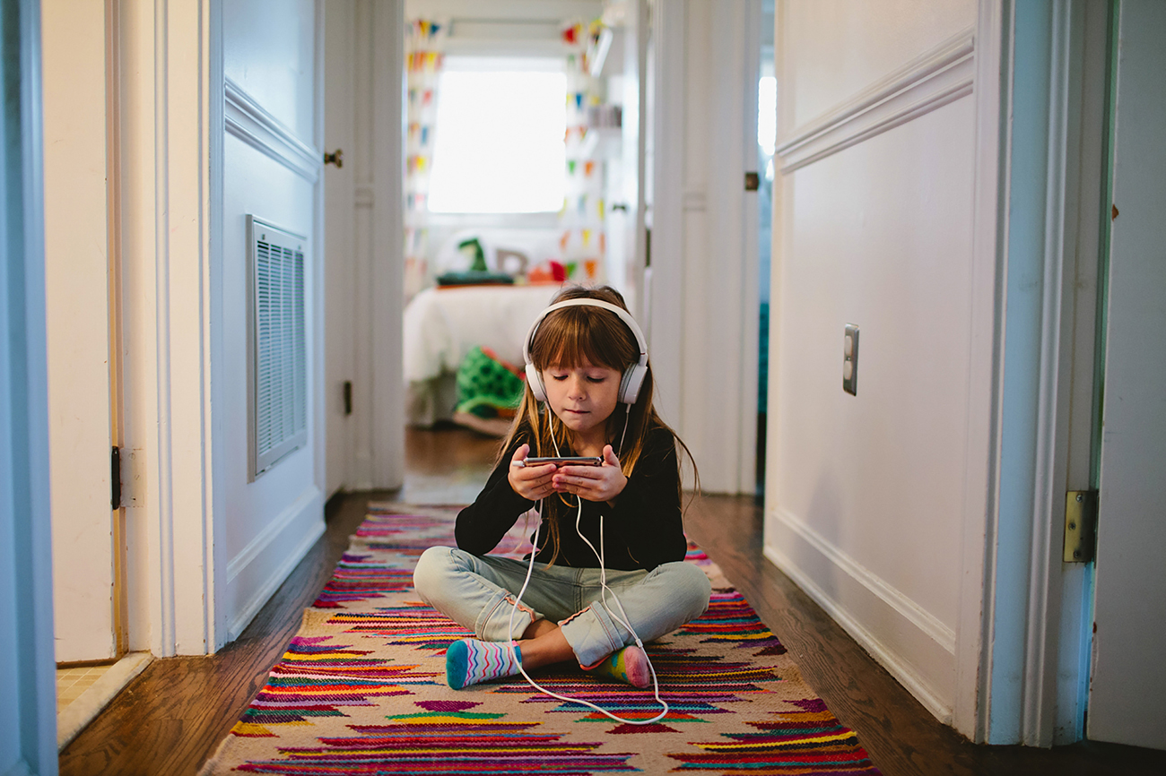 Girl listening to music in hallway