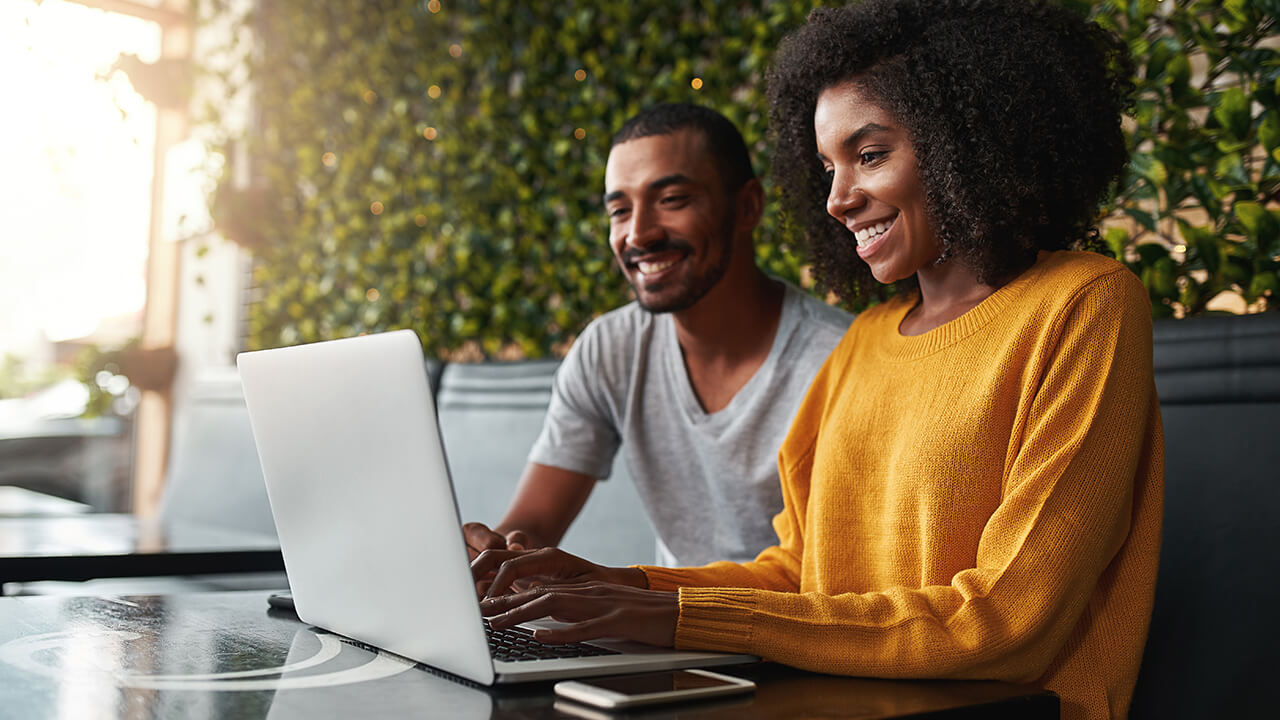 Young professional CPA couple on tablet outside