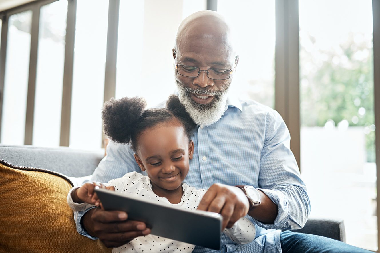 Granddad and child looking at tablet