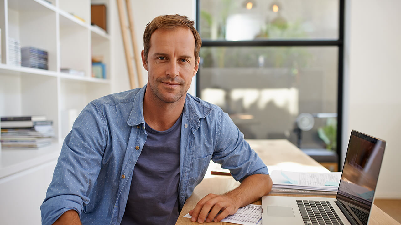 Professional male CPA in home office with laptop