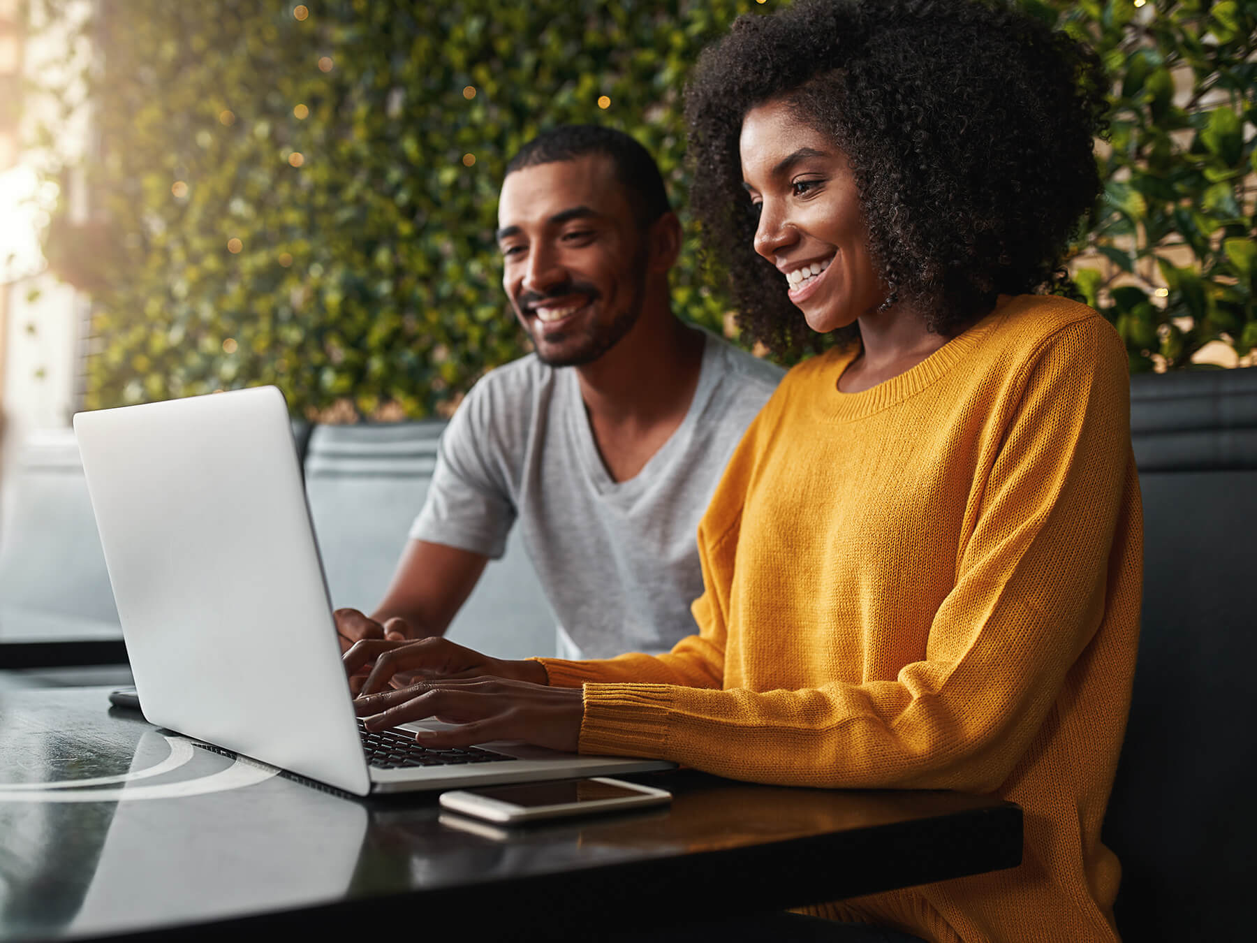 Young professional CPA couple on tablet outside