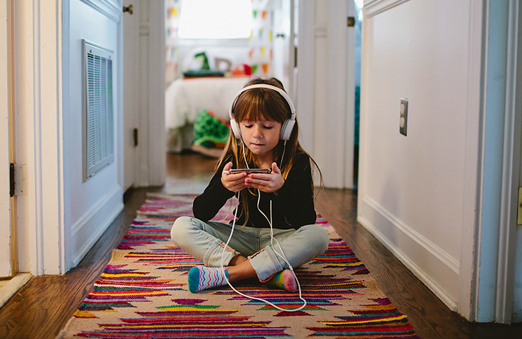 Girl listening to music in hallway